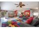 Open-concept living room with comfortable seating, unique lighting, and access to outdoor spaces at 3022 N 148Th Ave, Goodyear, AZ 85395