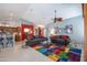 Bright living room with high ceilings, tile floor, comfortable seating, and colorful accent rug at 3022 N 148Th Ave, Goodyear, AZ 85395
