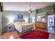 Spacious main bedroom with wooden floors, ceiling fan, and access to the bathroom at 3022 N 148Th Ave, Goodyear, AZ 85395