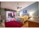 Spacious main bedroom with wooden floors, ceiling fan, and a large picture window at 3022 N 148Th Ave, Goodyear, AZ 85395