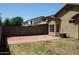 View of the backyard with grass and paver patio at 3559 N 143Rd Ave, Goodyear, AZ 85395