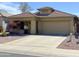 Front exterior of a single story home with large driveway at 3559 N 143Rd Ave, Goodyear, AZ 85395