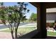 Inviting front porch view showcasing vibrant landscaping, a green lawn, and a peaceful neighborhood street at 3559 N 143Rd Ave, Goodyear, AZ 85395