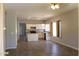 Open kitchen and dining area featuring tile flooring, white cabinetry, and views of other living spaces at 3559 N 143Rd Ave, Goodyear, AZ 85395