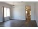 Bright, open-concept living room featuring tile flooring, a neutral color palette, and an arched doorway at 3559 N 143Rd Ave, Goodyear, AZ 85395