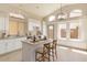 A charming kitchen with stainless steel sink and island, great natural light, and breakfast bar at 4923 W Wahalla Ln, Glendale, AZ 85308