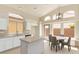Spacious kitchen boasts granite countertops, an island, and ample natural light from the large windows at 4923 W Wahalla Ln, Glendale, AZ 85308