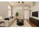 Bright living room features a neutral color palette, high ceilings, and updated ceiling fan at 4923 W Wahalla Ln, Glendale, AZ 85308