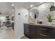 Chic bathroom featuring a black vanity, round mirror, and unique tile backsplash at 5995 N 78Th St # 2078, Scottsdale, AZ 85250