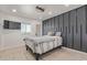 Modern bedroom featuring a gray accent wall, stylish light fixture, and wood-look flooring at 5995 N 78Th St # 2078, Scottsdale, AZ 85250