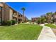 Well-maintained community courtyard with green grass, walking path, and inviting landscaping at 5995 N 78Th St # 2078, Scottsdale, AZ 85250