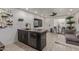 Open living area with dark kitchen bar, and comfortable sofa and entertainment area at 5995 N 78Th St # 2078, Scottsdale, AZ 85250