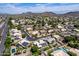 Panoramic aerial shot of a residential neighborhood nestled in a desert landscape with mountain views and green spaces at 6577 W Abraham Ln, Glendale, AZ 85308