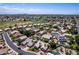 An aerial view of a residential area featuring manicured lawns, swimming pools, and proximity to a golf course at 6577 W Abraham Ln, Glendale, AZ 85308