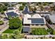 Aerial view of the property showcasing its solar panels, backyard pergola, and mature landscaping at 6577 W Abraham Ln, Glendale, AZ 85308
