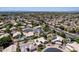 Expansive aerial view of a neighborhood showcasing lush landscaping, pools, and a well-planned community layout at 6577 W Abraham Ln, Glendale, AZ 85308