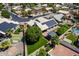 Aerial view of the property with putting green, showcasing solar panels, landscaping and backyard features at 6577 W Abraham Ln, Glendale, AZ 85308