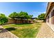 Large backyard with mature trees, custom pergola and ample space for relaxation and entertaining at 6577 W Abraham Ln, Glendale, AZ 85308
