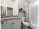 Updated bathroom with a granite vanity, tiled shower, and neutral color scheme at 6577 W Abraham Ln, Glendale, AZ 85308