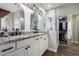 Modern bathroom with double sinks, granite counters, glass-enclosed shower, and walk-in closet at 6577 W Abraham Ln, Glendale, AZ 85308