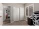 Bedroom featuring a closet, window with shutters, and neutral color palette at 6577 W Abraham Ln, Glendale, AZ 85308