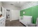 Cozy Bedroom with a white crib, sliding closet doors, and green accent wall at 6577 W Abraham Ln, Glendale, AZ 85308