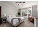 Calm main bedroom features a vaulted ceiling, large window, and soft decor at 6577 W Abraham Ln, Glendale, AZ 85308