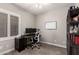 Office/bedroom featuring a desk, monitor, and bookshelf at 6577 W Abraham Ln, Glendale, AZ 85308
