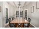 Bright dining room with large windows, modern light fixture, and seating for eight at 6577 W Abraham Ln, Glendale, AZ 85308
