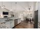Open concept kitchen with white cabinets, granite counters and stainless steel appliances at 6577 W Abraham Ln, Glendale, AZ 85308