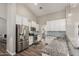 Bright kitchen featuring white cabinets, stainless steel appliances, and modern lighting at 6577 W Abraham Ln, Glendale, AZ 85308