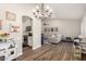 Open-concept living room features hardwood floors, modern lighting, and stylish decor at 6577 W Abraham Ln, Glendale, AZ 85308