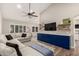 Bright and open living room featuring stylish flooring, a ceiling fan, and built-in storage cabinets at 6577 W Abraham Ln, Glendale, AZ 85308