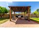 Outdoor covered patio with comfortable seating and brick pavers create an inviting outdoor living space at 6577 W Abraham Ln, Glendale, AZ 85308