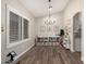 Bright playroom features stylish flooring, a chandelier, and a large window with plantation shutters at 6577 W Abraham Ln, Glendale, AZ 85308