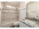 Bright bathroom with a tub-shower combo, mosaic tile accent, and a granite countertop vanity at 8516 W Saint John Rd, Peoria, AZ 85382