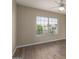 Bright bedroom with wood floor, ceiling fan, and a window offering outdoor views at 8516 W Saint John Rd, Peoria, AZ 85382