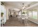 Open-concept dining room with natural light, wood floors, and views into the living room at 8516 W Saint John Rd, Peoria, AZ 85382