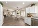 Open-concept dining room with white wood table set next to big windows and views into living area at 8516 W Saint John Rd, Peoria, AZ 85382