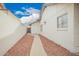 Clean side yard exterior featuring a white privacy wall and concrete walkway at 8516 W Saint John Rd, Peoria, AZ 85382