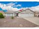 Beautiful single-story home with a three-car garage and low-maintenance desert landscaping at 8516 W Saint John Rd, Peoria, AZ 85382