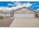 Charming single-story home showcasing a three-car garage and manicured desert landscaping at 8516 W Saint John Rd, Peoria, AZ 85382