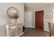 Inviting foyer featuring a decorative mirror, stylish cabinet, and modern flooring at 8516 W Saint John Rd, Peoria, AZ 85382