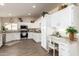 Bright kitchen featuring white cabinets, stainless steel appliances, and a functional built-in desk area at 8516 W Saint John Rd, Peoria, AZ 85382