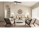 Bright living room with a ceiling fan, wood floors, and stylish decor at 8516 W Saint John Rd, Peoria, AZ 85382