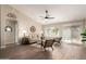 Comfortable living room with wood floors, ceiling fan, and a sliding glass door at 8516 W Saint John Rd, Peoria, AZ 85382