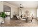 Spacious living room featuring a ceiling fan, wood floors, and access to other living spaces at 8516 W Saint John Rd, Peoria, AZ 85382