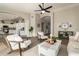 Open-concept living room featuring a ceiling fan, wood floors, and lots of light at 8516 W Saint John Rd, Peoria, AZ 85382