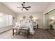 Comfortable main bedroom features a large bed with decorative pillows, a ceiling fan, and nice decor at 8516 W Saint John Rd, Peoria, AZ 85382