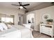 Main bedroom boasting an ensuite bath, lots of light, and a modern ceiling fan at 8516 W Saint John Rd, Peoria, AZ 85382